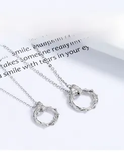 Close-up of dual S925 sterling silver necklaces with thorn ring pendant design