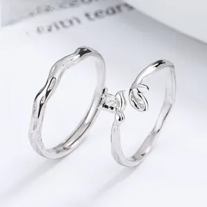 Macro shot of 925 sterling silver twin knot rings with minimalist leaf and wave design