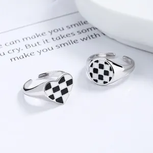 Detail of 925 sterling silver adjustable rings with trendy black and white checkered patterns