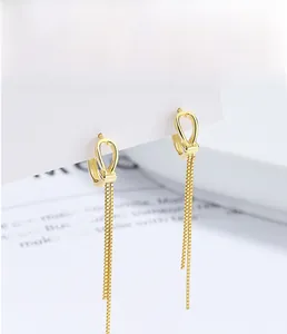 Close-up of 925 sterling silver tassel earrings with 18K gold plating on display card