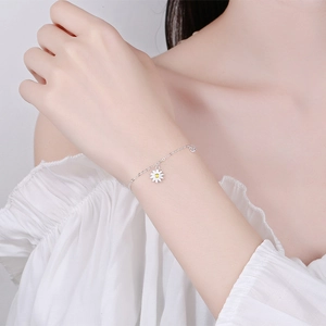 925 sterling silver daisy charm bracelet worn on wrist for a minimalist and elegant look