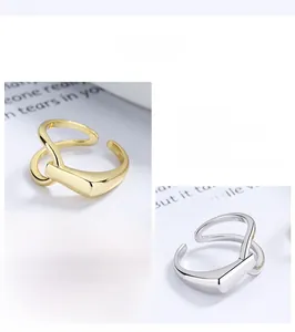 Close-up of geometric S925 sterling silver rings in polished gold and silver finishes