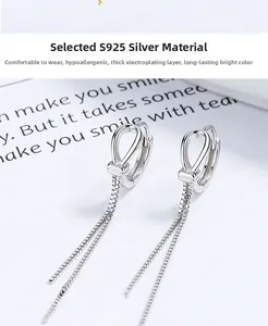 Detailed macro view of 925 sterling silver knotted long tassel earrings with box chains
