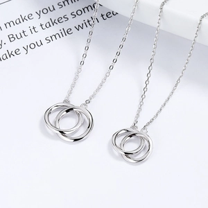 Minimalist 925 sterling silver Mobius interlocking double ring necklace on white prop card