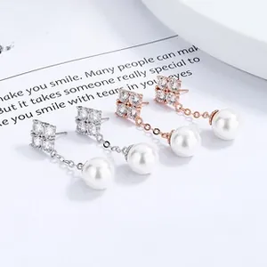 Detailed shot of S925 silver and rose gold waterdrop pearl earrings with cubic zirconia
