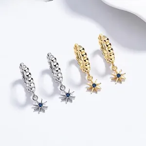 Detail view of 925 silver star hoop earrings in gold and silver with blue stones