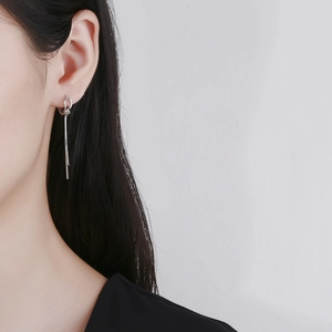 Elegant 925 sterling silver knotted tassel drop earrings on a female model's side profile