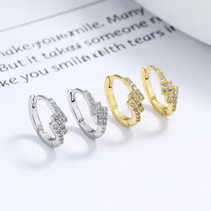 Detail view of gold and silver S925 sterling silver geometric earrings with pavé zircons