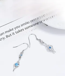 Close-up of S925 sterling silver fishhook earrings with sky blue round-cut zircon stones