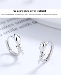 Detailed macro view of S925 sterling silver tulip hoop earrings with a polished finish
