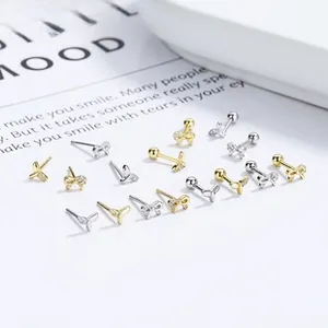 Detail of 925 silver fishtail and bow stud earrings with pearls and zircon stones