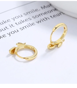 Macro shot of S925 sterling silver bunny ear hoop earrings with metal hallmark detail