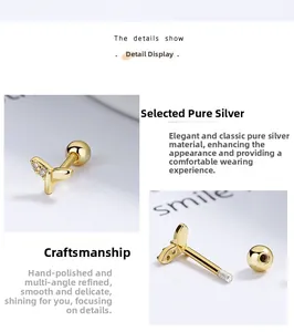 Macro detail of 925 sterling silver fishtail earring with gold finish and screw back