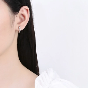 Elegant 925 sterling silver tulip flower hoop earrings worn by a model for a stylish look