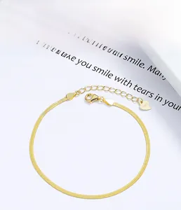 Macro shot of 925 sterling silver flat snake chain bracelet with heart tag and lobster clasp