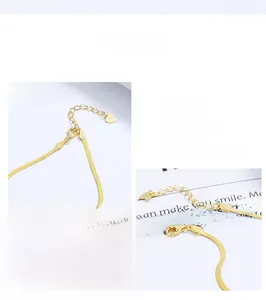 Detail view of the gold S925 sterling silver flat snake chain bracelet with lobster clasp