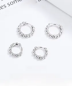 Macro detail of S925 sterling silver stamp on textured bead hoop earrings for women