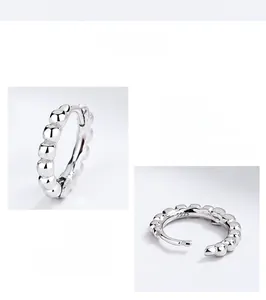 Detailed view of polished S925 sterling silver beaded hoop earrings with hinge closure