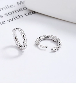 Close-up of S925 sterling silver beaded hoop earrings with polished finish and hallmark