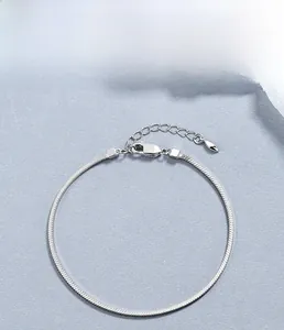 Detail of 925 sterling silver square snake chain bracelet with heart charm and lobster clasp