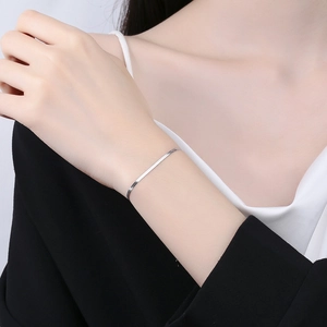 Minimalist 925 sterling silver flat snake chain bracelet on female model wrist