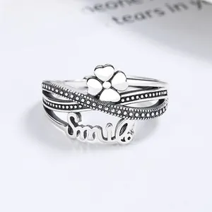 Macro shot of S925 sterling silver ring with smile engraving and clover motif details