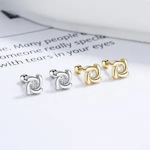 Detailed view of silver and gold windmill stud earrings with screw back and sparkling zircon