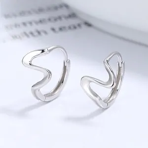 Detailed close-up of S925 sterling silver wavy hoop earrings with high polished finish