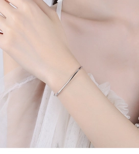 Detail of minimalist 925 sterling silver square snake chain bracelet on wrist