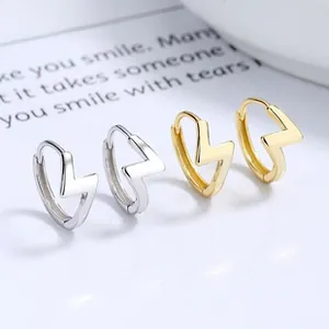 Detailed view of sterling silver lightning bolt hoop earrings in gold and silver finishes
