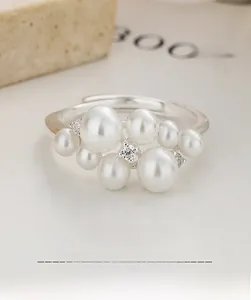 Detail of adjustable S925 silver ring with a cluster of eight white pearls and zircons