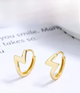 Detail of s925 silver lightning bolt earring with high-quality gold plating finish
