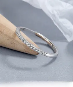 Macro shot of a 925 sterling silver band ring featuring a row of delicate pavé crystals