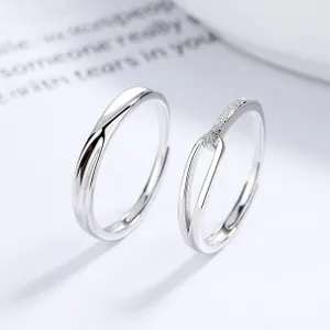 Detail of 925 sterling silver couple rings with Mobius twist and pavé zirconia inlay