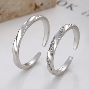 Detail of S925 sterling silver couple rings showing the Mobius twist and zirconia inlay