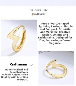 Macro detail of S925 sterling silver lightning bolt hoop earring in polished gold finish