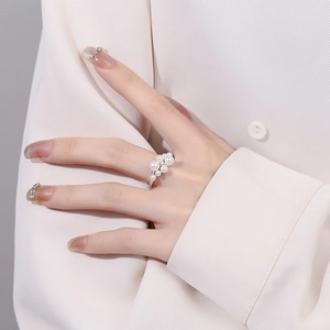 Elegant 925 sterling silver ring featuring a cluster of white pearls with adjustable open band