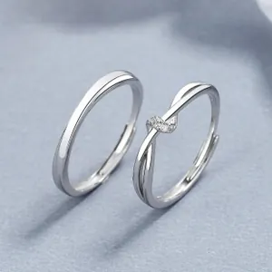 Close-up of 925 silver Mobius couple rings featuring a minimalist design and zircon inlay