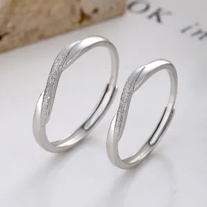 Close-up of 925 sterling silver Mobius couple rings with polished and frosted finish