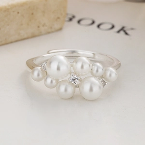 Close-up of 925 sterling silver ring with cluster pearls and sparkling zirconia stones