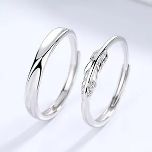 Detailed macro view of 925 sterling silver couple rings with feather design and zircon inlay