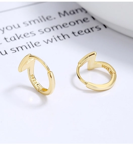 Detailed view of gold S925 sterling silver lightning bolt hoop earrings with logo hallmark