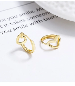 Macro shot of 925 sterling silver hollow heart hoop earrings in gold finish with S925 stamp