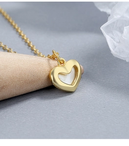 Macro shot of S925 hallmark on heart necklace with white mother of pearl inlay
