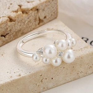 925 silver pearl ring with cluster design and adjustable open band on a stone surface