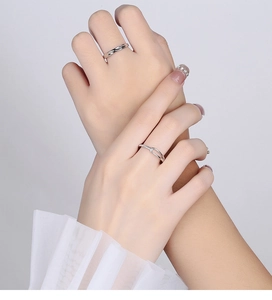 Close-up of 925 silver couples ring set with micro-pave cubic zirconia on a model
