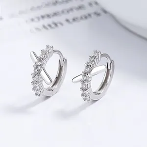 Close-up of 925 sterling silver hoop earrings with pave-set zircon cross details