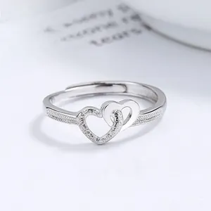 Detailed macro view of S925 silver ring featuring intertwined dual heart design
