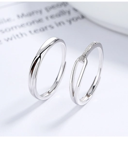 Detail of 925 sterling silver couple rings with twisted wave and textured patterns
