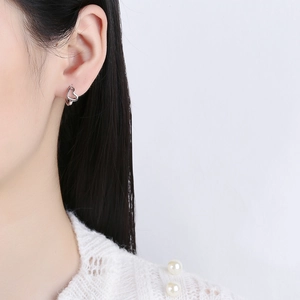 Minimalist 925 sterling silver hollow heart hoop earrings on female model